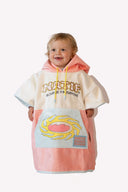 Poncho rose et blanc Natif pour enfant avec un style good vibes de sunrise et sunshine surf, ultra doux et avec lacet refermable