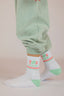 Paire de chaussettes blanche et verte pour les enfants avec le style e la marque de vêtements Natif