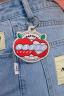 Porte-clés Apple Market de la marque d'accessoires Natif avec ses pommes et broderies.