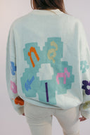 Sweater snow coupe vent couleur crème avec une fleurs en version pixel